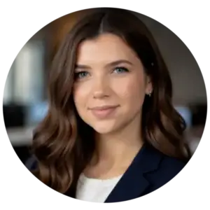 Professional portrait of a smiling woman with shoulder-length brown hair wearing a navy blazer and white top.